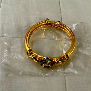 Gold tone & rhinestones detailed bracelet.  Opens up to fit any wrist.